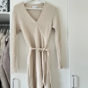Beige ribbad omlottklänning från NA-KD - Säljer en stilren beige ribbad omlottklänning från Vila. Använd en jul. 