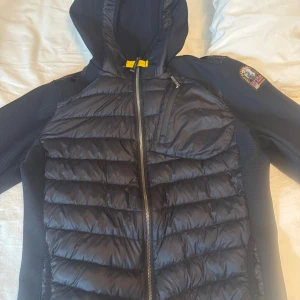 Svart jacka från Parajumpers - Säljer en svart Parajumpers jacka med huva och dragkedja. Jackan är i fint skick och har inga defekter. Tvättas självklart innan den fraktas. Köpt för 4049kr på kids brandstore. Passar än perfekt om man är mellan  160-170cm. Om man har mer frågor eller vill ha mer bilder bara att skriva privat. Jackan passar perfekt nu till våren