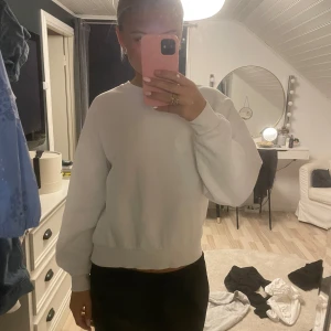 Vit sweatshirt från Gina Tricot - Säljer en supermjuk och bekväm vit sweatshirt från Gina Tricot, perfekt för en avslappnad look. Den har långa ärmar och ribbade muddar vid ärmslut och nederkant. Endå i bra skick och inget nopper osv 🥰