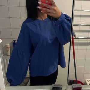 Blå tröja - Blå tröja som har volang vid armen, är som ny.