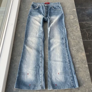 Coola jeans  - Coola jeans med röda detaljer. Inerbenslängd 75    Midje mått rakt över- 33