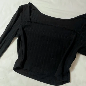 Svart ribbad topp - Snygg svart ribbad topp med långa ärmar och en ”fyrkantig” urringning. Perfekt för en trendig look. Kontakta mig om du har frågor☺️