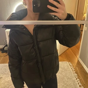 Svart pufferjacka från Bik Bok - Säljer en svart pufferjacka från Bik Bok i storlek XS. Bikbok jackan som var populär för nått år sedan men har ingen luva till. Den har en hög krage och justerbara snören. 