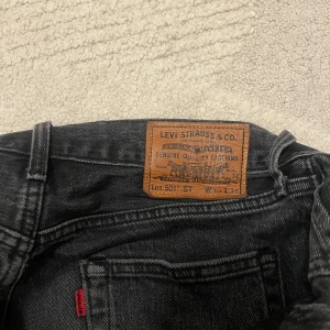 Svarta Levi's 501 jeans - Säljer ett par klassiska svarta Levi's 501 jeans i mycket bra skick. De har en straight passform och är tillverkade i slitstarkt denim. Perfekta för både vardag och fest! Storlek W30 L34.