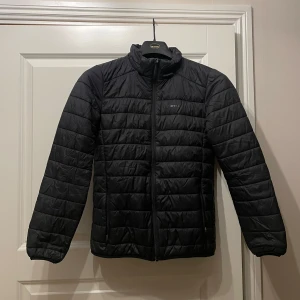 Svart quiltad jacka från Everest - Säljer en svart quiltad jacka från Everest i mycket bra skick. Den har en dragkedja framtill och är perfekt för höst och vår. Jackan är långärmad och har en stilren design som passar till det mesta. Perfekt för dig som vill hålla dig varm och snygg samtidigt!