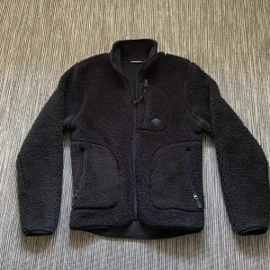 J.Lindeberg fleece jacka - Säljer denna sjukt snygga och gosiga fleece jackan från J.Lindeberg. Den kostar nypris 2000kr men ja säljer nu för 900kr riktig steal då den endast är använd 3 gånger ungefär. (För liten)  Den är väldigt varm och passar till allt. Håller dig varm i alla väder ner till 5 minusgrader ungefär! Ställ gärna frågor!
