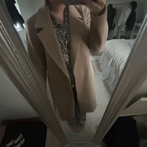 Begie/brun lång kappa - Säljer denna varma höst/vinter kappa från VILA. Den är i ett tjockt material och går därför att ha kallare höstdagar och varmare vinterdagar. Den är i storlek S/38, säljer då den inte kommer till användning🩷nypris 859kr