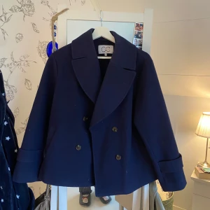 Mörkblå kappa från coster copenhagen - Säljer en mörkblå kappa från coster copenhagen. Använd ca 2 gånger så den är som ny. Superfin!