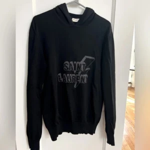 Saint Laurent Hoodie - Tja! Säljer denna sjukt limiterade och snygga YSL hoodie! Orörd från Vestiaire Collective och därmed legit checkad. Stl M men är en elastisk hoodie så passar både större och mindre! Tar endast emot seriösa köpare || pm/funderingar || Mvh!