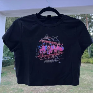 Svart croppad t-shirt med tryck - Svart croppad t-shirt med tryck. Säljer den pga att den aldrig blivit använd 🥰 Den är liten i storleken då den passar mig som har S 🌸  (ALDRIG ANVÄND)  Längd: 42 cm Axel: 37 cm