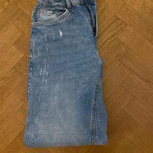 Säljer ett par klassiska blå jeans från Lindex i storlek 13-14y / 164. De har en straight passform och är perfekta för vardagsbruk. Jeansen är i bra skick och har en snygg ljusblå tvätt. 