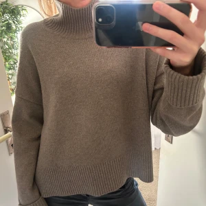 Stickad tröja med polo från Arket - Supersnygg stickad polotröja i ull! Går att vika ner i nacken om man vill ha en lägre polo. Slit på sidorna och armar som går att veckla ut ifall man vill ha de längre. Storlek L men passar S/M!