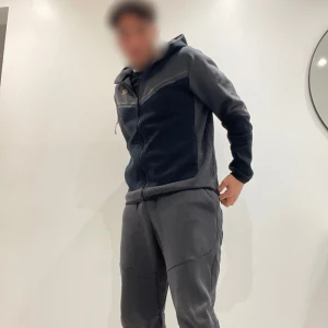 Nike tech fleece tracksuit grå svart - Nike tech tracksuit i storlek M, väldigt bra skick 8/10 har inte används så mycket, nypris 2200.