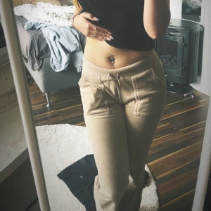Beige mjukisbyxor med snörning - Säljer ett par juicy couture, bekväma beige med snörning i midjan. Byxorna har fickor både fram och bak. Använda typ 2 gånger!