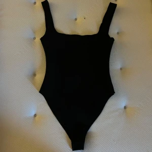 Svart body  - FLYTTAR UTOMLANDS 2 FEBRUARI Använd en gång, har knappar nedtill