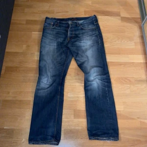 Blå jeansbyxor - Säljer ett par klassiska blåa avarage joe jeansbyxor med en straight passform. Byxorna har en snygg tvättad look och är utrustade med både fram- och bakfickor. Perfekta för en avslappnad stil. Denna byxa average joe har dock några sidoeffekter här och där. Det finns samanlagt tre håll på dessa byxor. Kom gärna med prisförslag! Och ni vill ha mer bilder säg till!