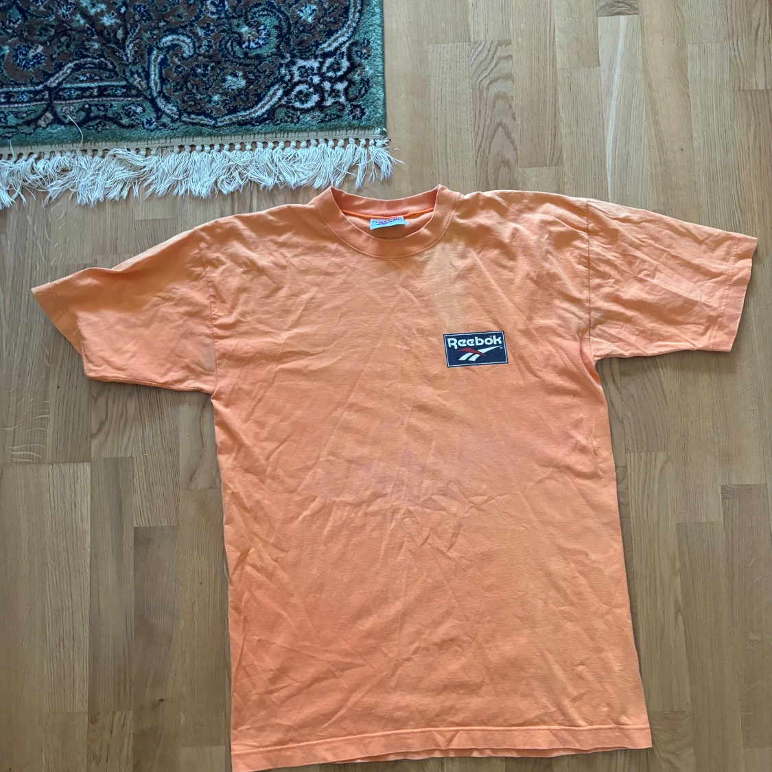 Orange t-shirt från Reebok