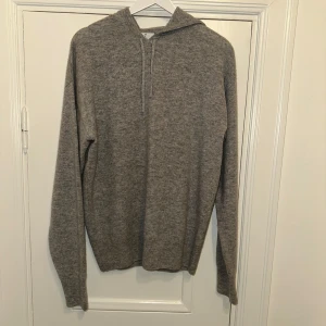 Kashmir Hoodie - Säljer en stilren grå kashmir hoodie från Carmés i storlek M. Perfekt nu under vintern. Hör av dig vid frågor!