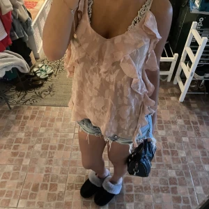 Zara topp - Säljer denna jätte fina beige/rosa aktiga topp från zara med volanger och ett fint mönster! Denna topp funkar lika bra på fest såsom i skolan🔥🥰🪅