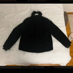 Svart teddy jacka från hm - Säljer min svarta teddy jacka då jag har en liknande. Den har dragkedja och är lång i ärmen. 