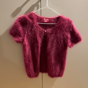 Vinröd angorakofta  - Fluffig vinröd kofta i 70% angoraull. Väldigt sparsamt använd. 