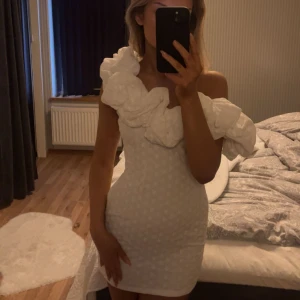 Studentklänning - Säljer denna otroligt fina klänning som både passar till sommaren och student. Säljer denna då jag beslutat mig för en annan studentklänning men är som helt ny. Klänningen går även att ha som off-shoulder men går även att ha på en axel som på bilden. 