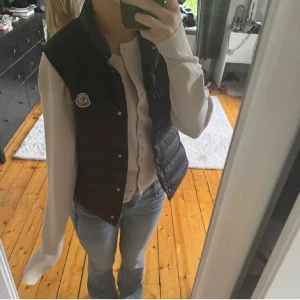 Moncler väst - Säljer min Moncler väst för super pris. Använd 2 gånger. Märket är lite nopprigt men har inte större deffekter. Den är äkta och QR koden funkar. Dock har jag slarvat bort kvitto. 🥰 Nypris: runt 4500kr