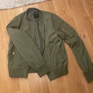 Militär grön bomberjacka - Militär grön bomberjacka med roseguld dragkedja.