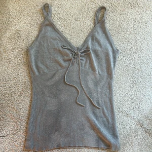 Glittrig topp - Glittrig topp från Orsay, står ingen storlek men den passar S/M