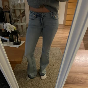 Ljusblå jeans med bootcut - Säljer ett par ljusblå jeans med bootcut-stil. De har en klassisk femficksdesign och är lågmidjade för en bekväm passform. Perfekta för en avslappnad look. De är i storlek 36 och passar mig i längden och jag är 173💕