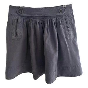 Grå kjol från See by Chloé - Snygg mörkblå kjol från See by Chloé med knappar och dragkedja. Kjolen har en klassisk design med veckade detaljer framtill och en dragkedja bak. Perfekt för en stilren look.