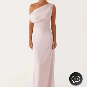 Ljusrosa one-shoulder klänning i satin - Heart Of Glass Satin Maxi Dress - Pink. Aldrig använd! Väldigt snygg och ser mer ut som satin i verkligheten🥰 Säljer då jag beställde två storlekar 