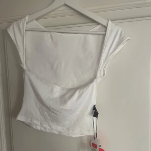 T-shirt med öppen rygg - Fin topp med öppen rygg, lappen kvar och oanvänd!