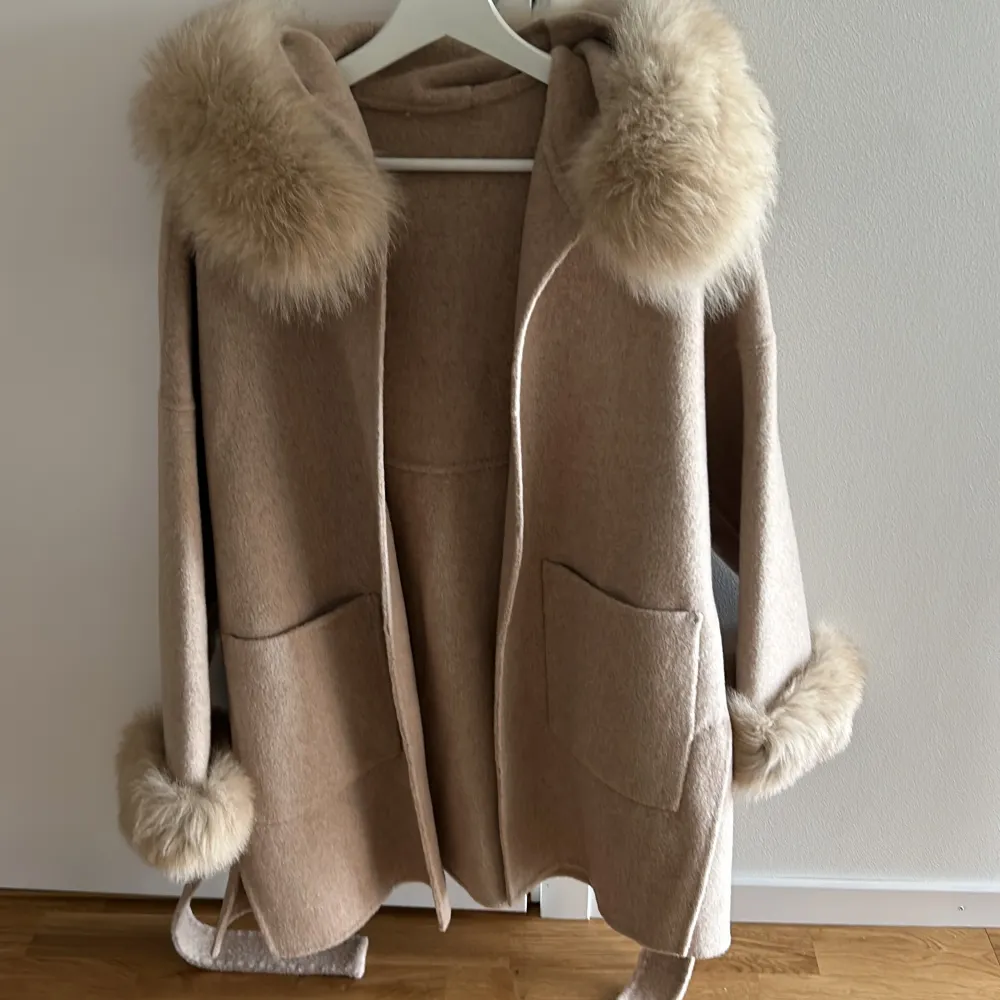 Beige kappa med äkta päls (som kan tas av) i storlek XS, kappan är Oversized och kan ses som normal storlek S/M. Har endast använt 2 gånger så den är som ny. . Jackor.