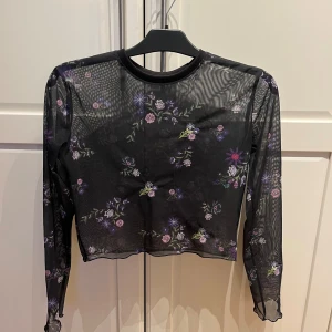 Tröja - Svart genomskinlig tröja med blommor. Har använt några gånger men den är i bra skick. Köparen står för frakt. Vet ej märket eller storlek. Jag har M/L och tröjan sitter lite tajt så skulle säga XS/S