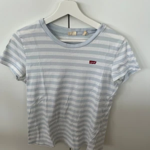 Randig t-shirt från Levi’s - Jättefin randig t-shirt från levi’s. Fint skick, endast en liten fläck som tyvärr inte gått bort med vanlig tvätt men har ej provat något starkare medel (som säkert hade fått bort fläcken).Över lag väldigt fint skick, skönt material, passar till allt
