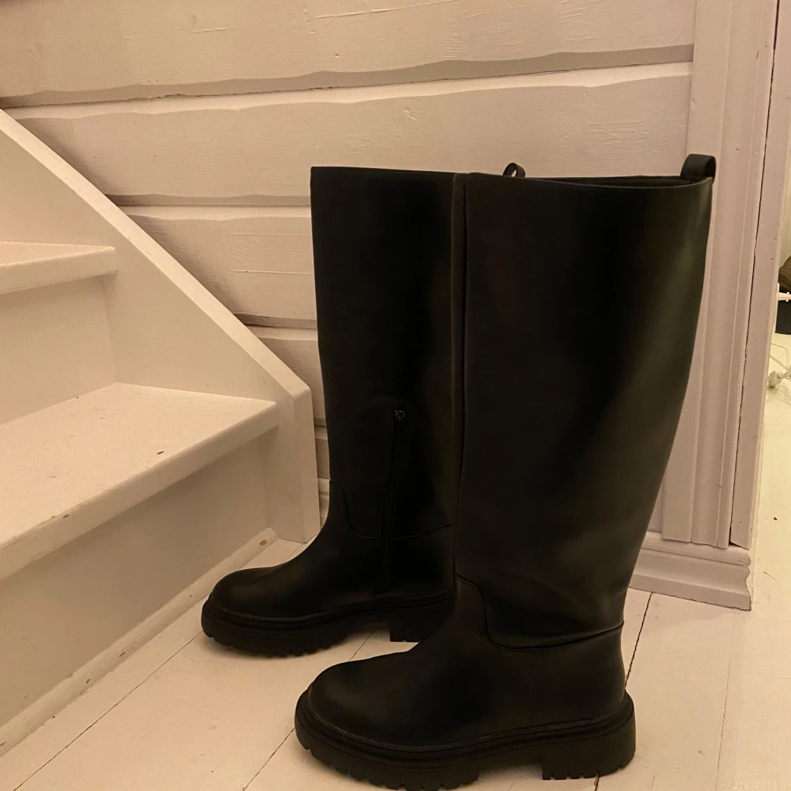 Svarta höga stövlar med dragkedja