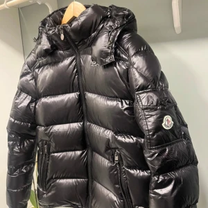 Svart dunjacka från Moncler - Hej! Jag säljer min Moncler Maya som är helt ny och aldrig använd. Om du är intresserad eller har frågor, tveka inte att höra av dig! Priset kan diskuteras.
