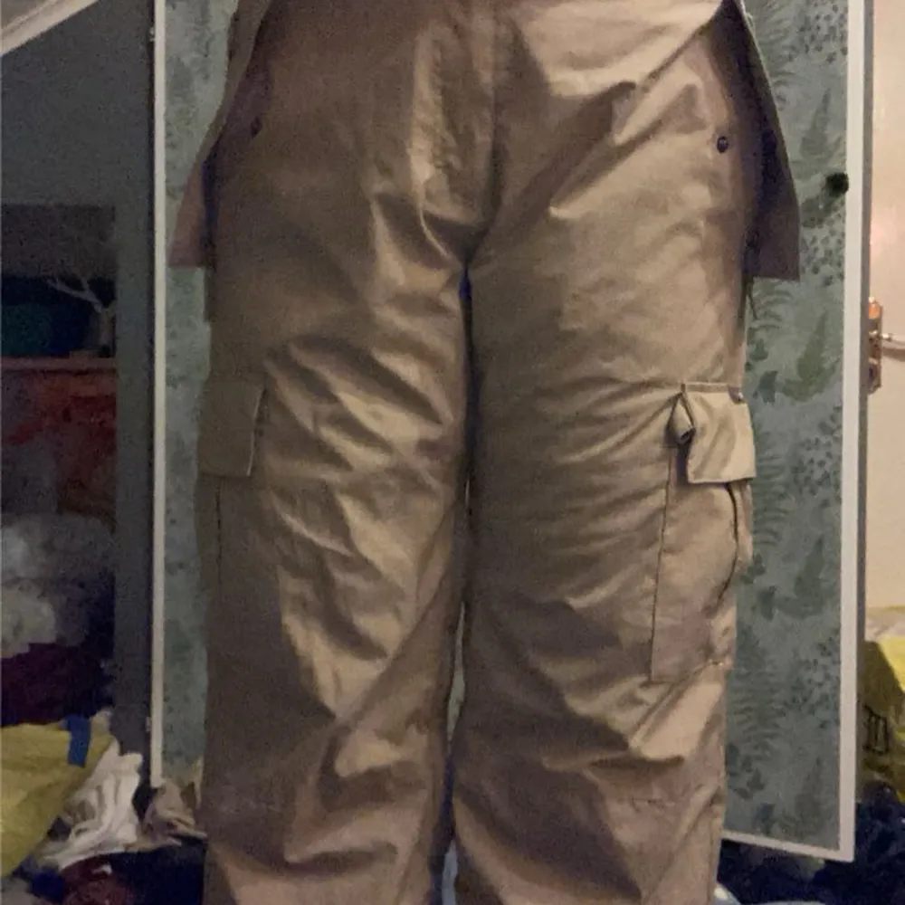 Säljer ett par beige skidbyxor från Quiksilver med flera fickor.. Farkut & Housut.