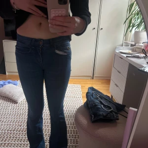 Blå bootcut jeans - Snygga blå bootcut jeans med en klassisk femficksdesign. De har en medel midja och en bekväm passform som ger en smickrande siluett. Perfekta för en avslappnad stil. Är i storlek 24x30 passar mig som är 163 ungefär 