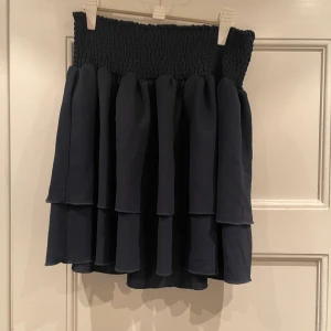 Volangkjol - En mörkblå volangkjol från Vila👗 Använd bara 1 gång, så den är i superfint skick. Storlek L men liten i storleken och passar på mig som är 170cm lång.