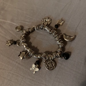Armband  - Super fint silvrigt armband med berlocker runt💞sparsamt använt.