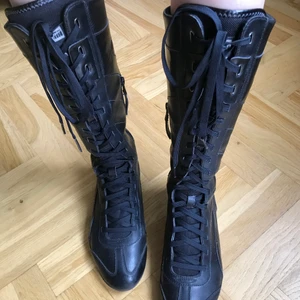 Puma boxing boots - Knee high laced boots with zippers on the sides. One shoe is a bit ripped at the back (shown on the last photo).