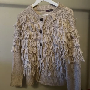 Stickad kofta - Stickad kofta i storlek S, köpt i en boutique på Marstrand. Sista knappen har lossnat.