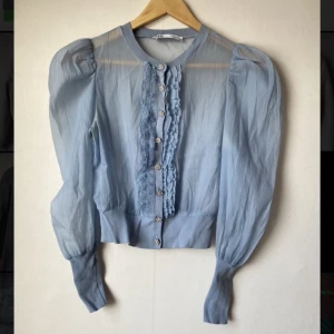 Light blue, sheer blouse with button and grill details - Unworn - perfect condition 