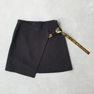 Black industrial mini skirt with buckle detail