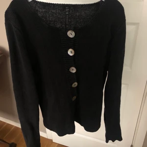 Svart kofta - Svart stickad kofta/tröja. Storlek s men passar nog xs bättre. Går att ha både knäppt och uppknäppt.