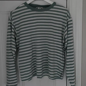 Långärmad  - En långärmad grön vit randig tröja från monki. Skönt material och är i väldigt bra skick. Storlek xxs men passar s och xs. Köparen står för frakten.