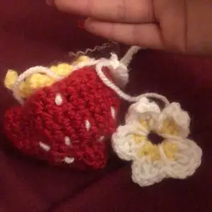 Strawberry crochet with a white flower 