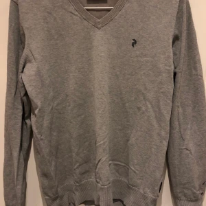 Peak Performance tröja - V-ringad peak tröja, passar som overshirt till skjorta. Inga hål men lite färg på vänster arm, går säker bort men har inte testat. Nypris 1100kr